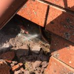 leaking pipe in brick wall
